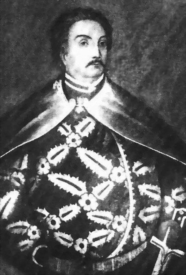 Schwarzes und weißes Foto von Papst Johannes Paul II. in Priesterrobe, der eine schwarze Robe mit weißem Kragen und Manschetten trägt und seine Hände verschränkt, mit ernster Miene und direktem Blick.