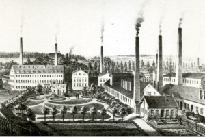 Schwarz-weiß-Zeichnung einer Fabrik mit rauchenden Schornsteinen, umgeben von Gebäuden, Grünflächen und einem Zaun, beschriftet mit "New York State Penitentiary" unten.