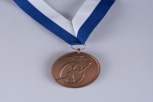 Gold medal with blue and white ribbon on white background, featuring inscribed text.