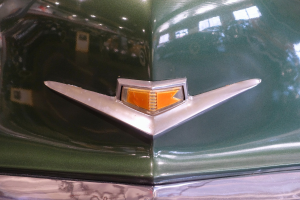 Nahaufnahme eines leuchtend grünen Autos mit einem sichtbaren Abzeichen.